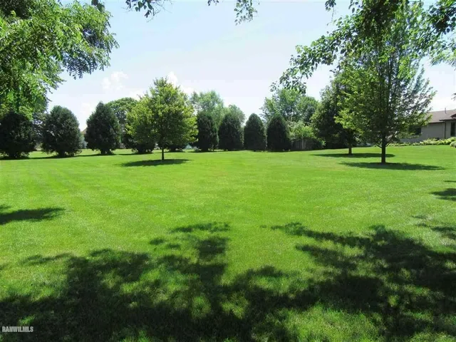 a view of field with trees in the background
