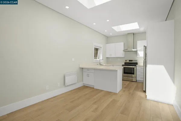 a kitchen with a refrigerator and a stove top oven