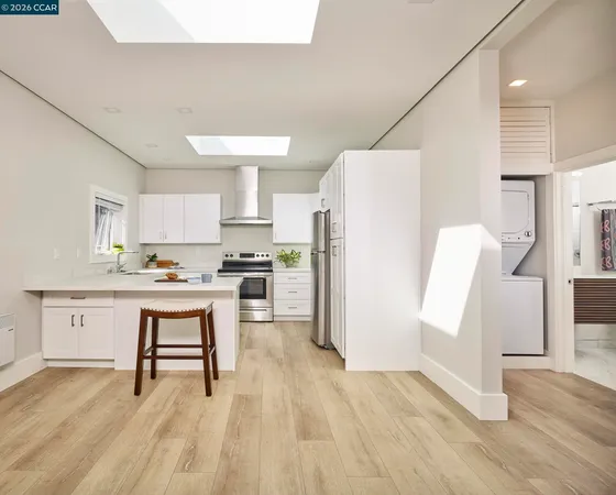 a kitchen with a refrigerator a sink and cabinets