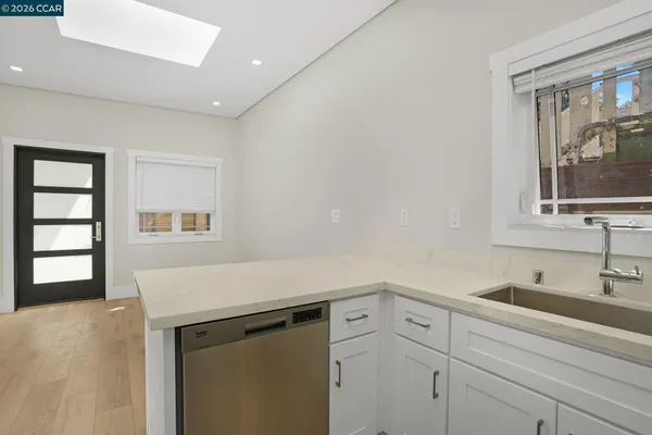 a view of a sink storage and utility room with window