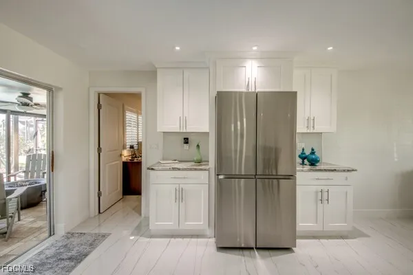 a bedroom with a bed and chandelier