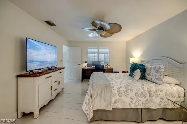 a view of a patio with table and chairs potted plants