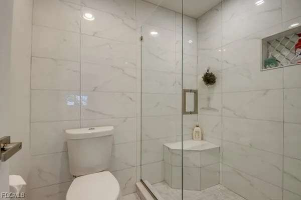 a living room with furniture and floor to ceiling windows