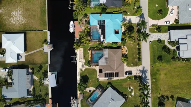 a kitchen with stainless steel appliances granite countertop a stove top oven a sink a dining table and chairs with wooden floor