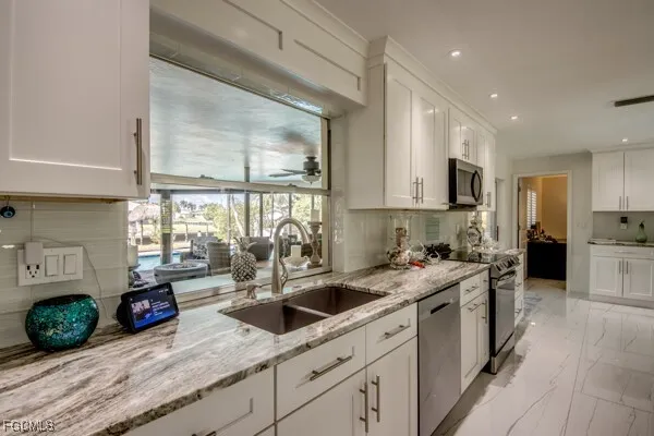 a living room with furniture a floor to ceiling window and a flat screen tv