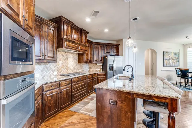 a view of kitchen with granite countertop cabinets and wooden floor