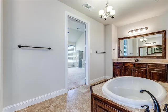 a bathroom with a tub sink and mirror