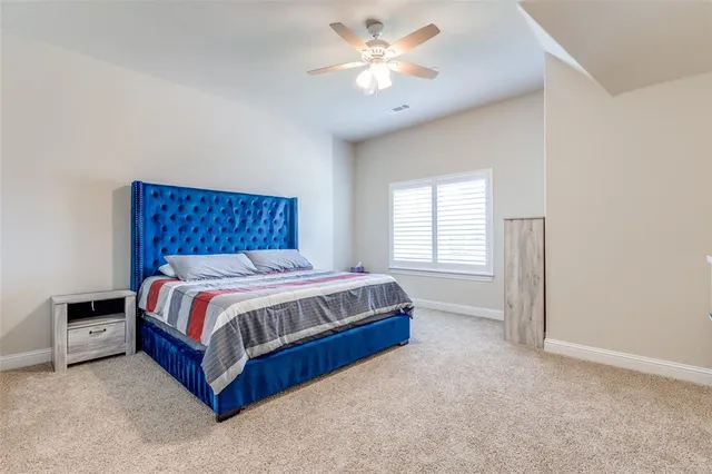 a spacious bedroom with a bed and window