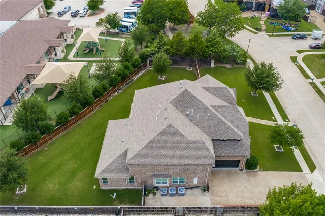 an aerial view of a house with swimming pool and garden