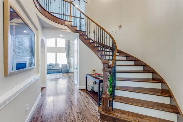 a view of entryway and hall with wooden floor