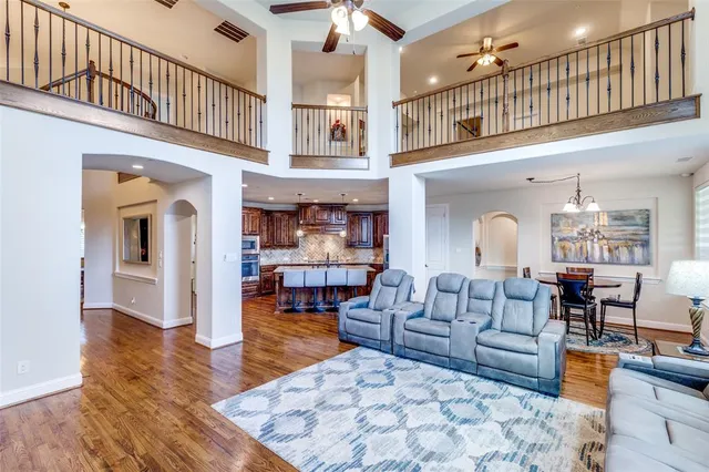 a living room with fireplace furniture and a rug