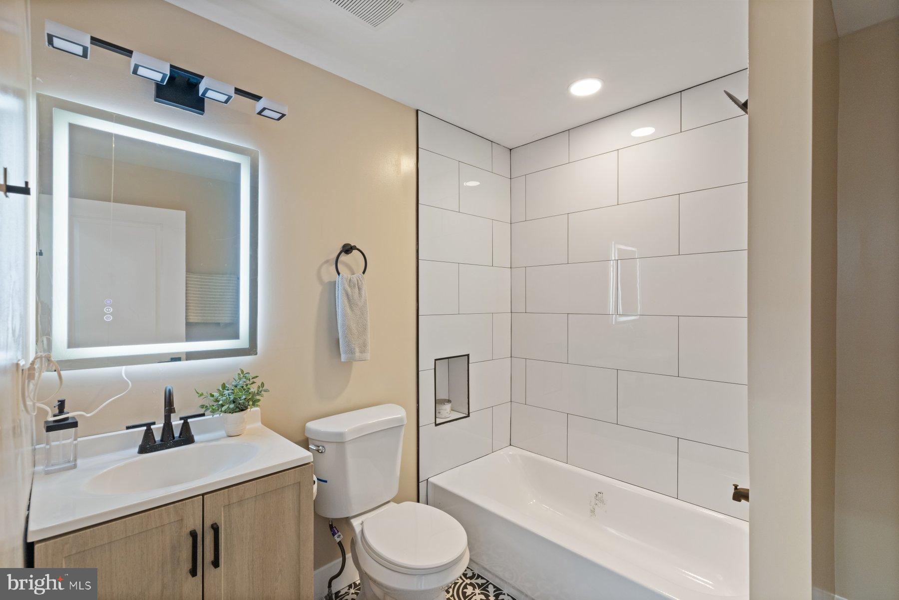 4632 Old Court Road Pikesville, MD 21208 - Photo 22 of 34 a bathroom with a sink a toilet and shower