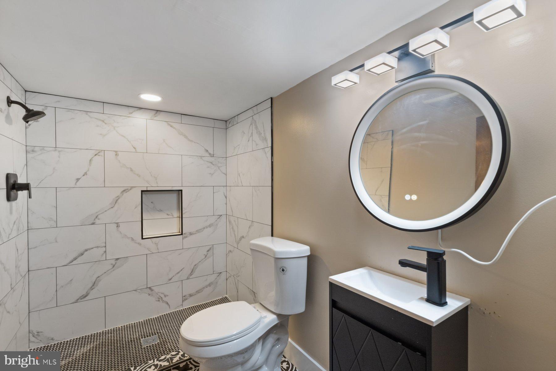 4632 Old Court Road Pikesville, MD 21208 - Photo 24 of 34 a bathroom with a toilet a sink a mirror and vanity
