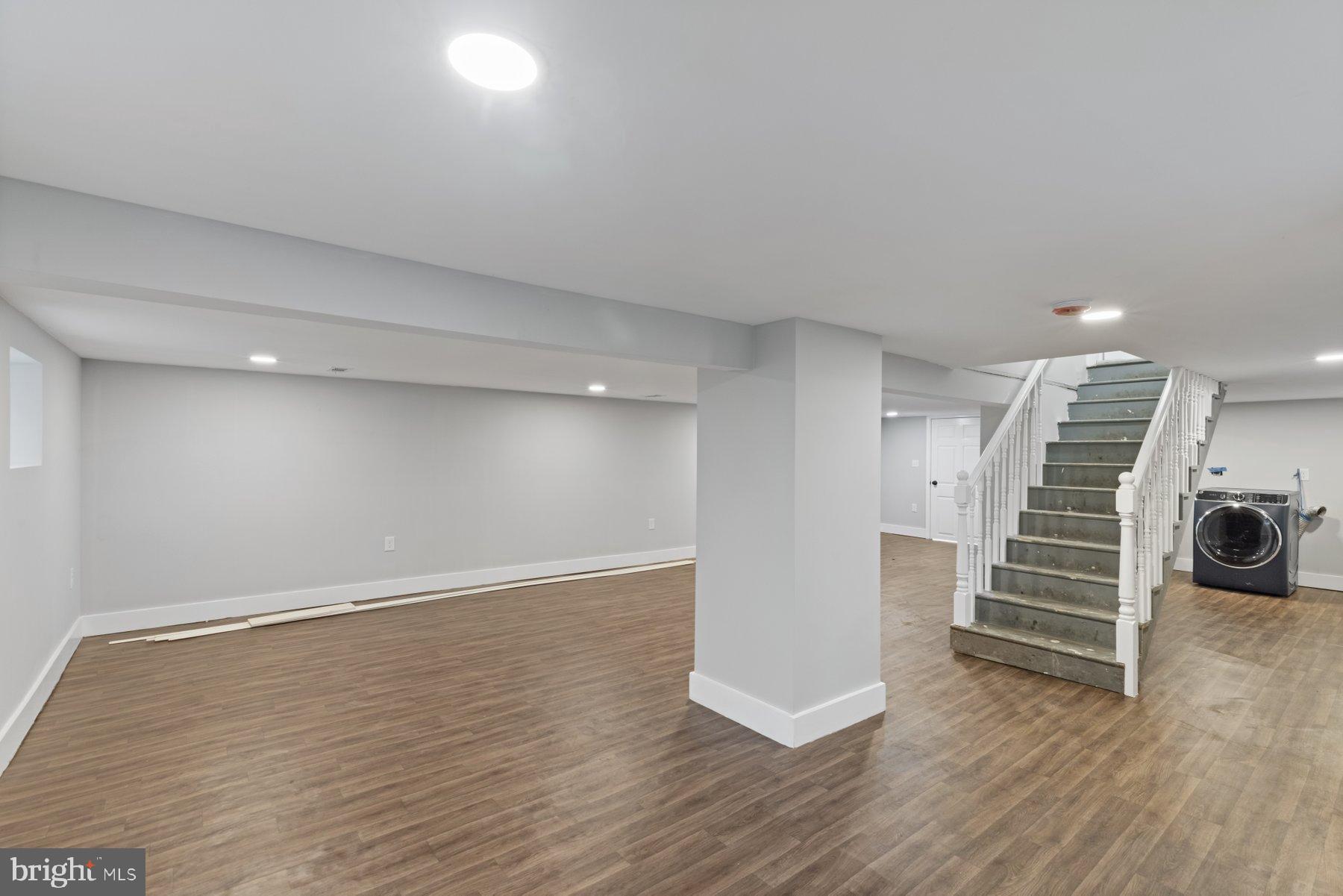 4632 Old Court Road Pikesville, MD 21208 - Photo 27 of 34 a view of room with stairs and a floor to ceiling window