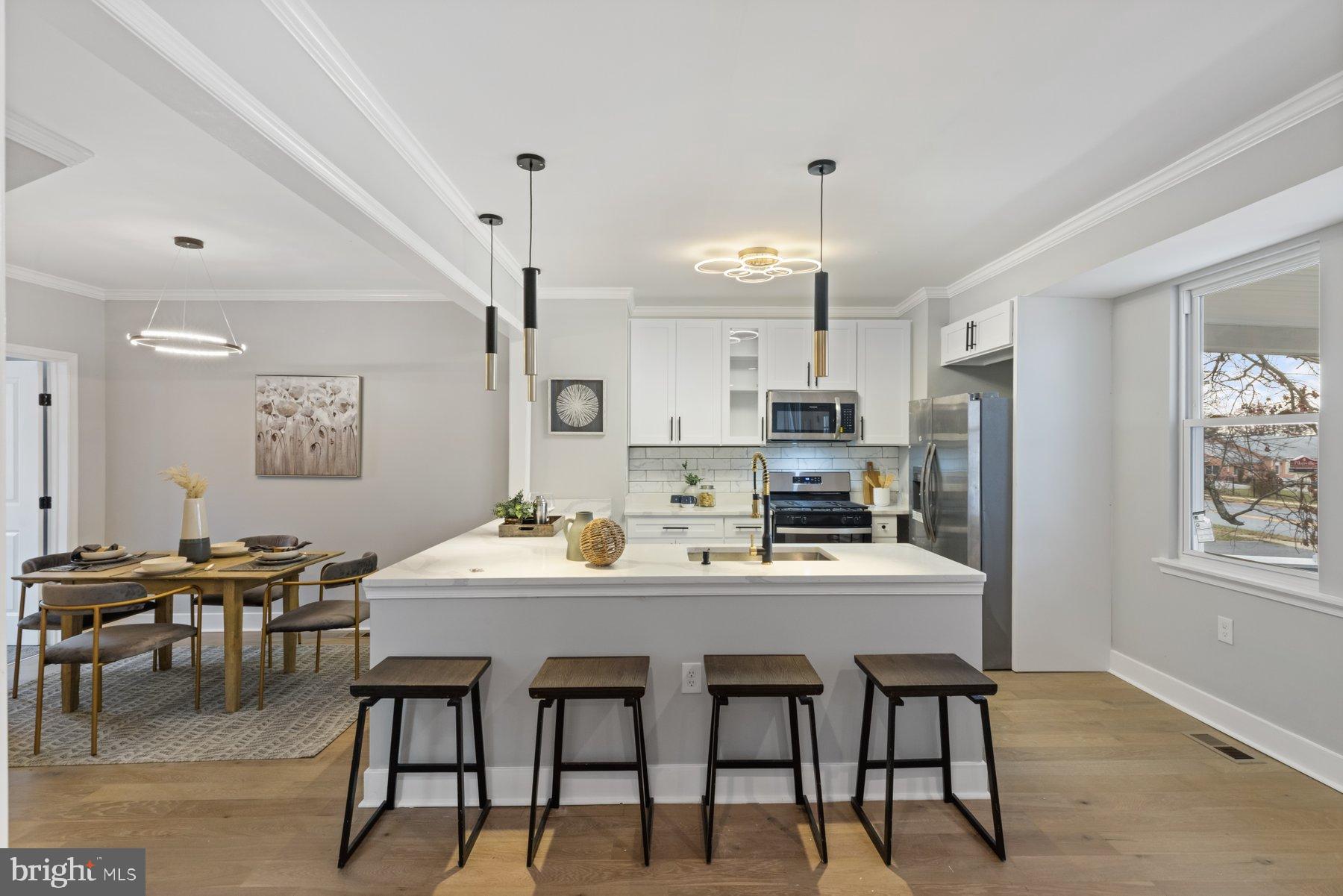 4632 Old Court Road Pikesville, MD 21208 - Photo 8 of 34 a kitchen with kitchen island a dining table and chairs
