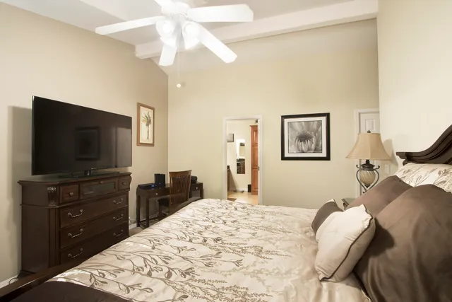 a bedroom with a bed and a flat screen tv