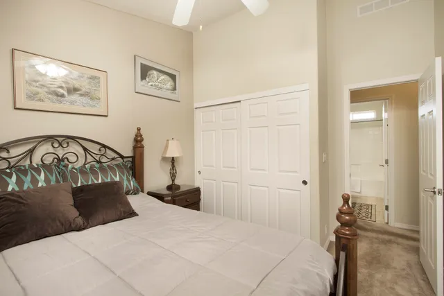 a bedroom with a bed and a painting on the wall