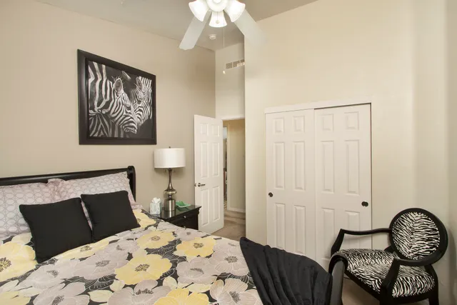 a bedroom with a bed and chair