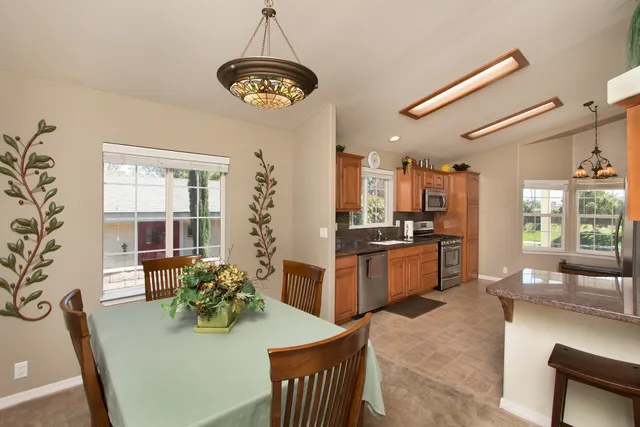 a large kitchen with a table and chairs