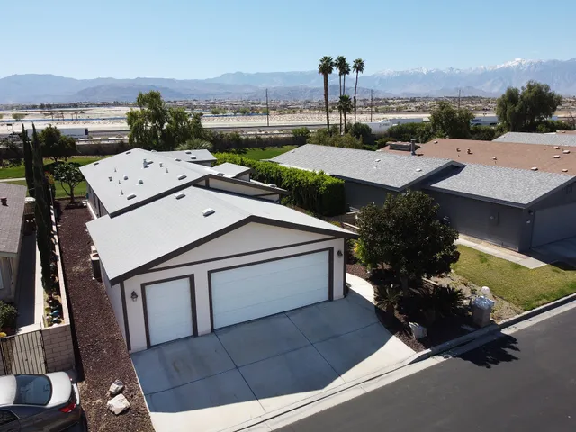 an aerial view of a house with a yard basket ball court and outdoor seating