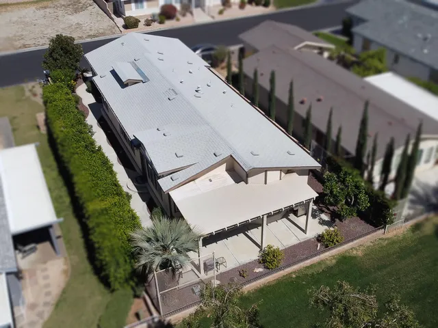 a view of a backyard with plants and outdoor seating