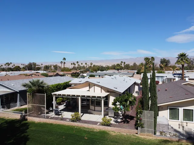 a view of a town with many buildings and large trees