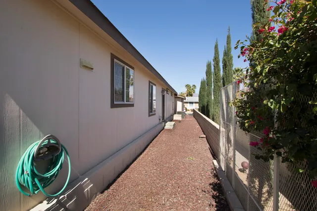 a balcony with wooden floor and potted plants
