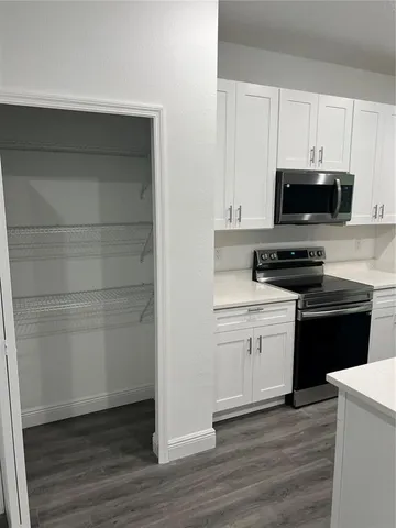 a kitchen with a sink and a stove top oven