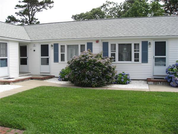 178 Captain Chase Road, Unit 12 Dennis, MA 02639 - Photo 1 of 4 a front view of house with yard and green space