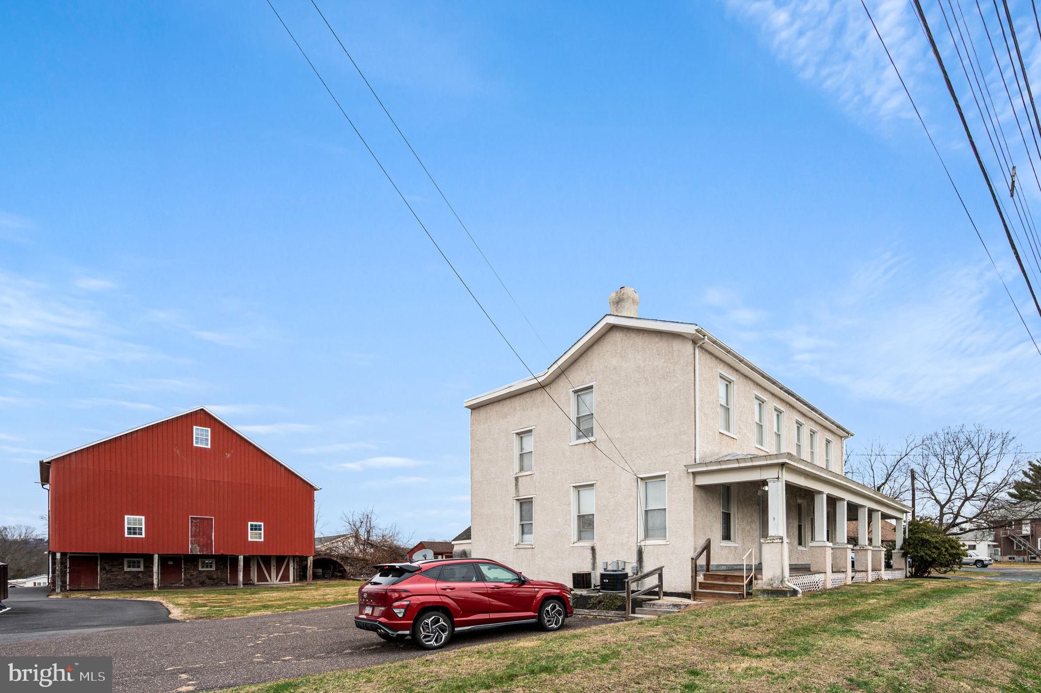 2933 East High Street Pottstown, PA 19464 - Photo 16 of 22 a front view of a house with a garden and parking space
