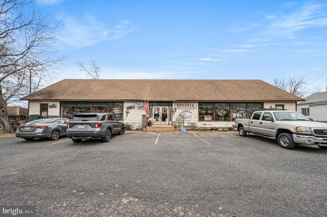 a view of a room with lots of wooden furniture