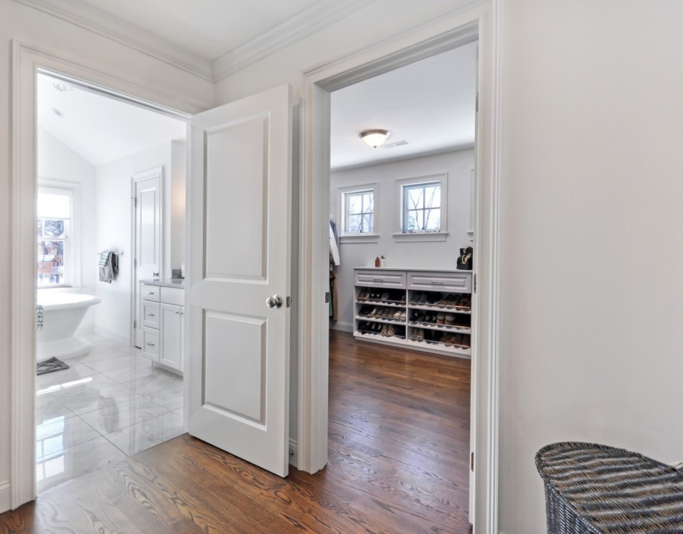291 Monsen Road Concord, MA 01742 - Photo 18 of 26 a view of a hallway with wooden floor and a bathroom