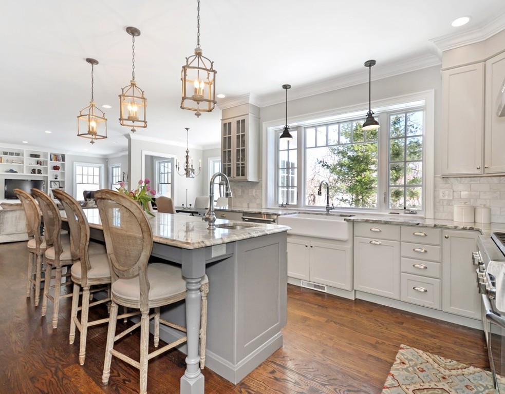 291 Monsen Road Concord, MA 01742 - Photo 6 of 26 a kitchen with stainless steel appliances granite countertop a stove a sink dishwasher a dining table and chairs with wooden floor