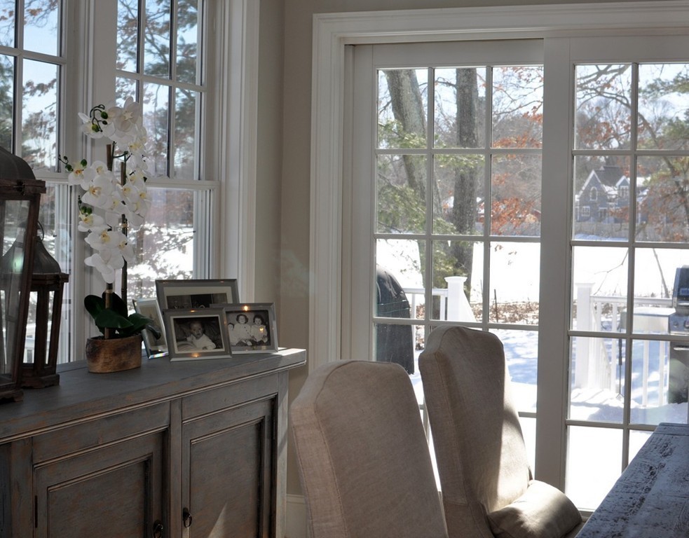 291 Monsen Road Concord, MA 01742 - Photo 9 of 26 a dining room with furniture a chandelier and wooden floor