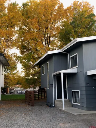 a view of a house with a yard and sitting area