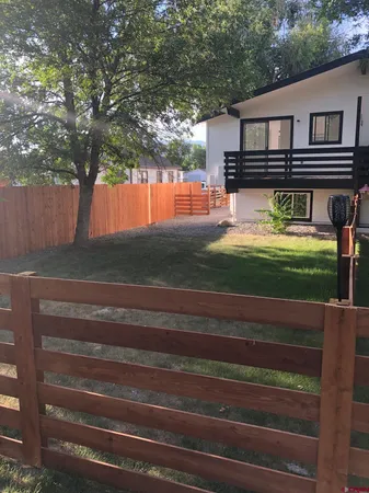 a front view of a house with a yard table and chairs