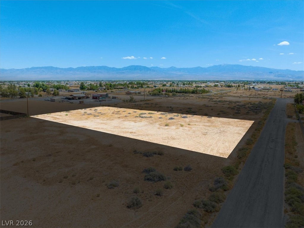 A prime plot of desert land awaits your vision with commanding mountain views.