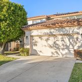 a pathway of a house with a yard
