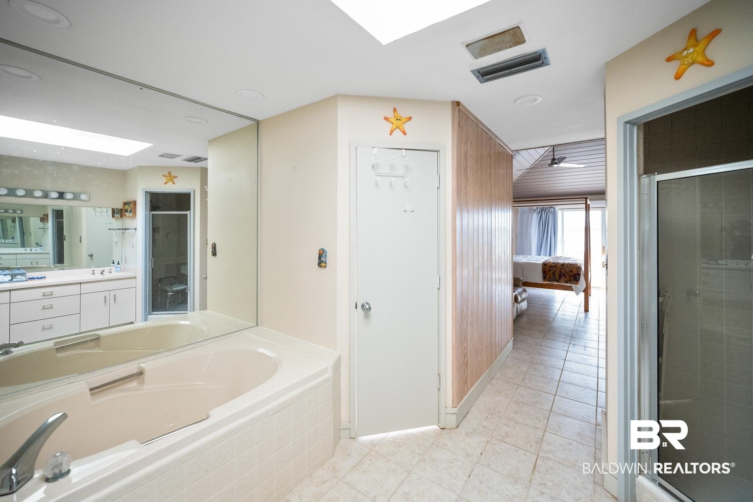 29255 Ono Boulevard Orange Beach, AL 36561 - Photo 35 of 43 Bathroom with vanity, a bath, a stall shower, and tile patterned flooring