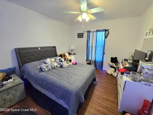 a bed room with a bed and a chandelier