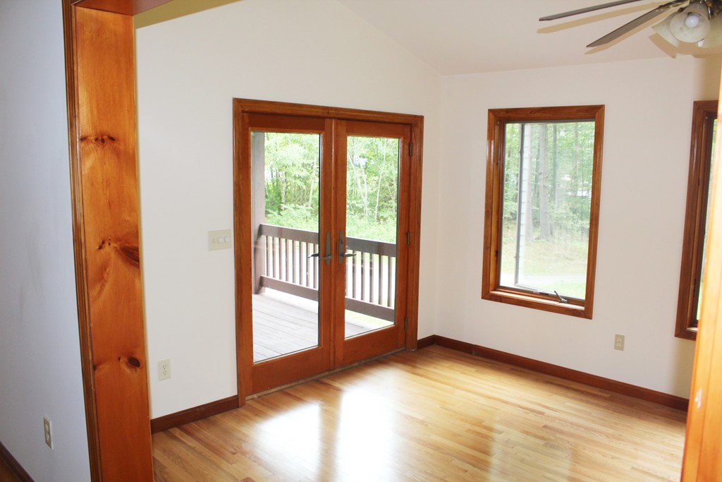 25 Little Watatic Pond Road Ashburnham, MA 01430 - Photo 12 of 18 a view of an empty room with wooden floor and a window