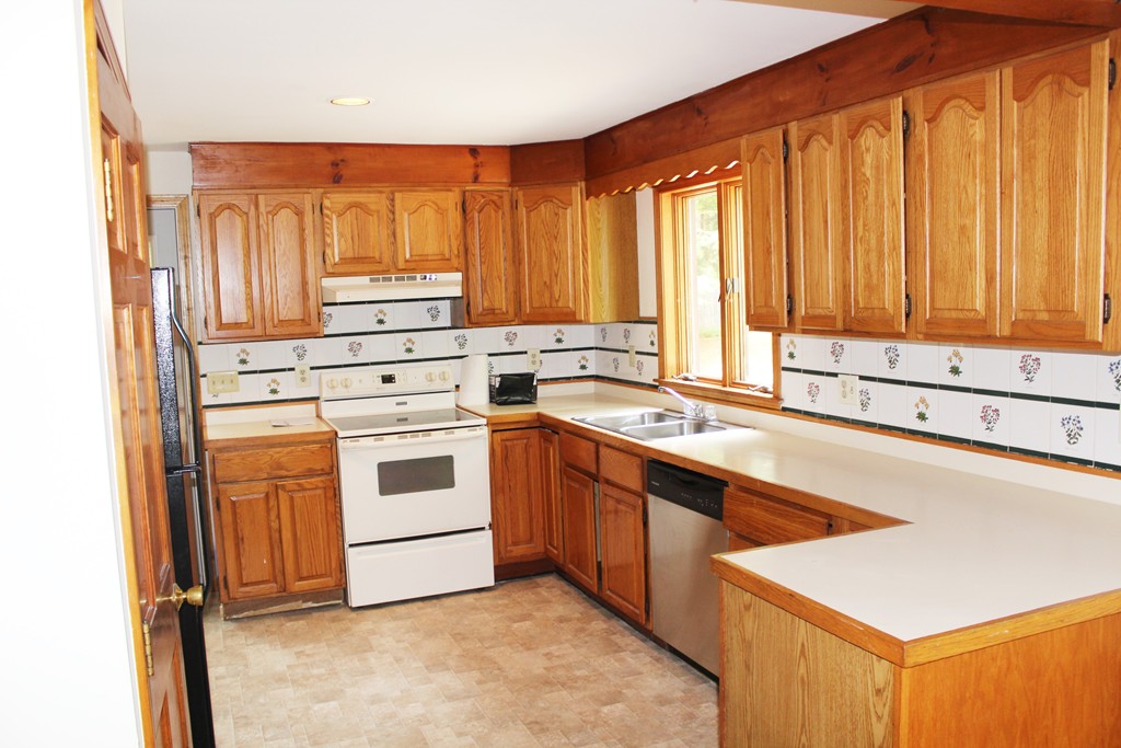 25 Little Watatic Pond Road Ashburnham, MA 01430 - Photo 6 of 18 a kitchen with a stove a sink and a refrigerator