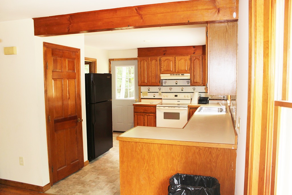 25 Little Watatic Pond Road Ashburnham, MA 01430 - Photo 7 of 18 a kitchen with a refrigerator a stove top oven a washer and dryer
