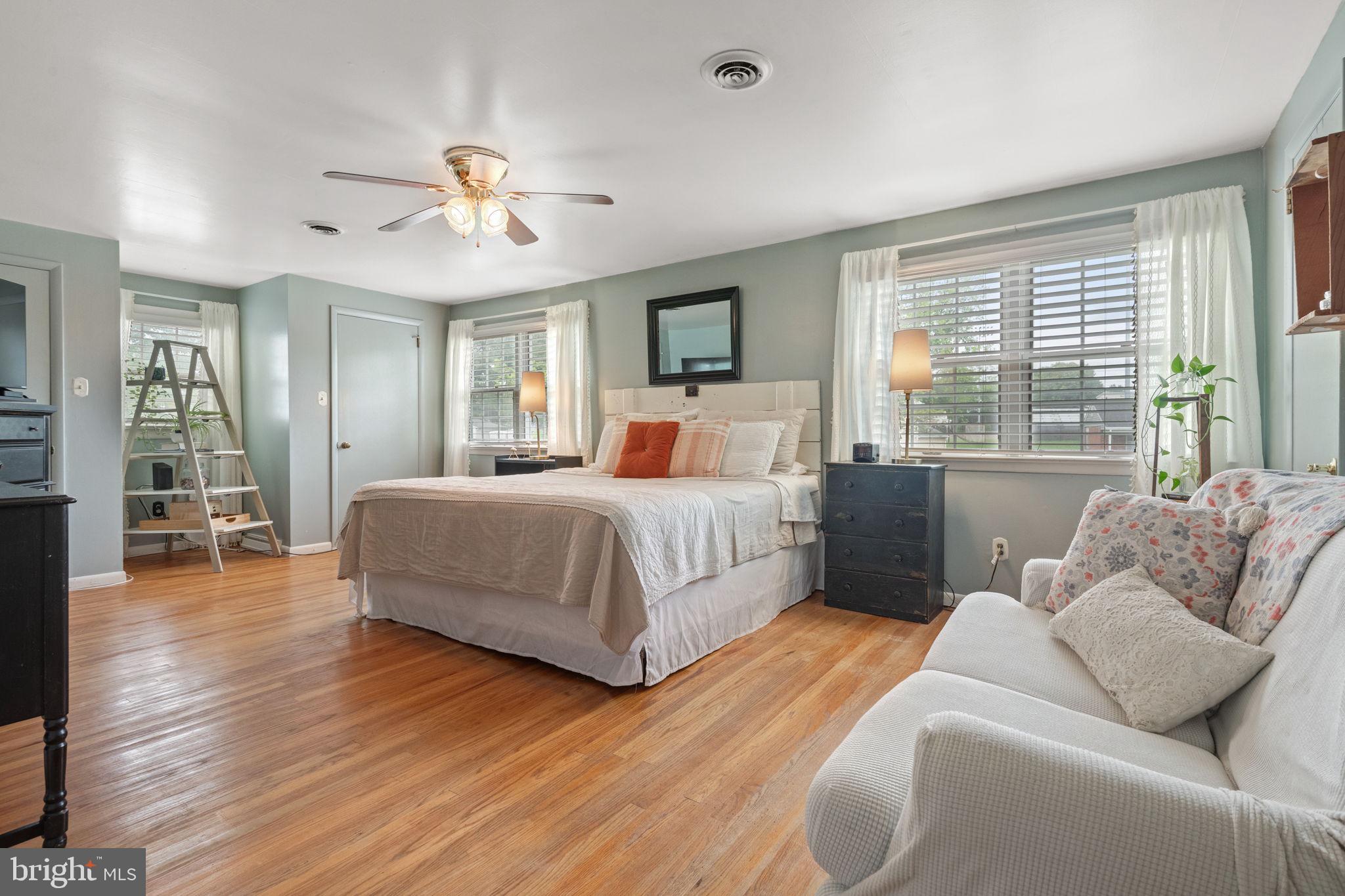 1818 Longview Drive Lancaster, PA 17601 - Photo 30 of 49 a bedroom with a large bed a chandelier and windows