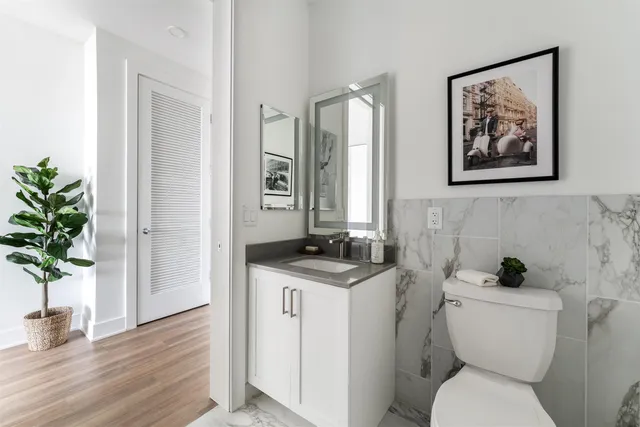 a bathroom with a toilet a sink and a mirror