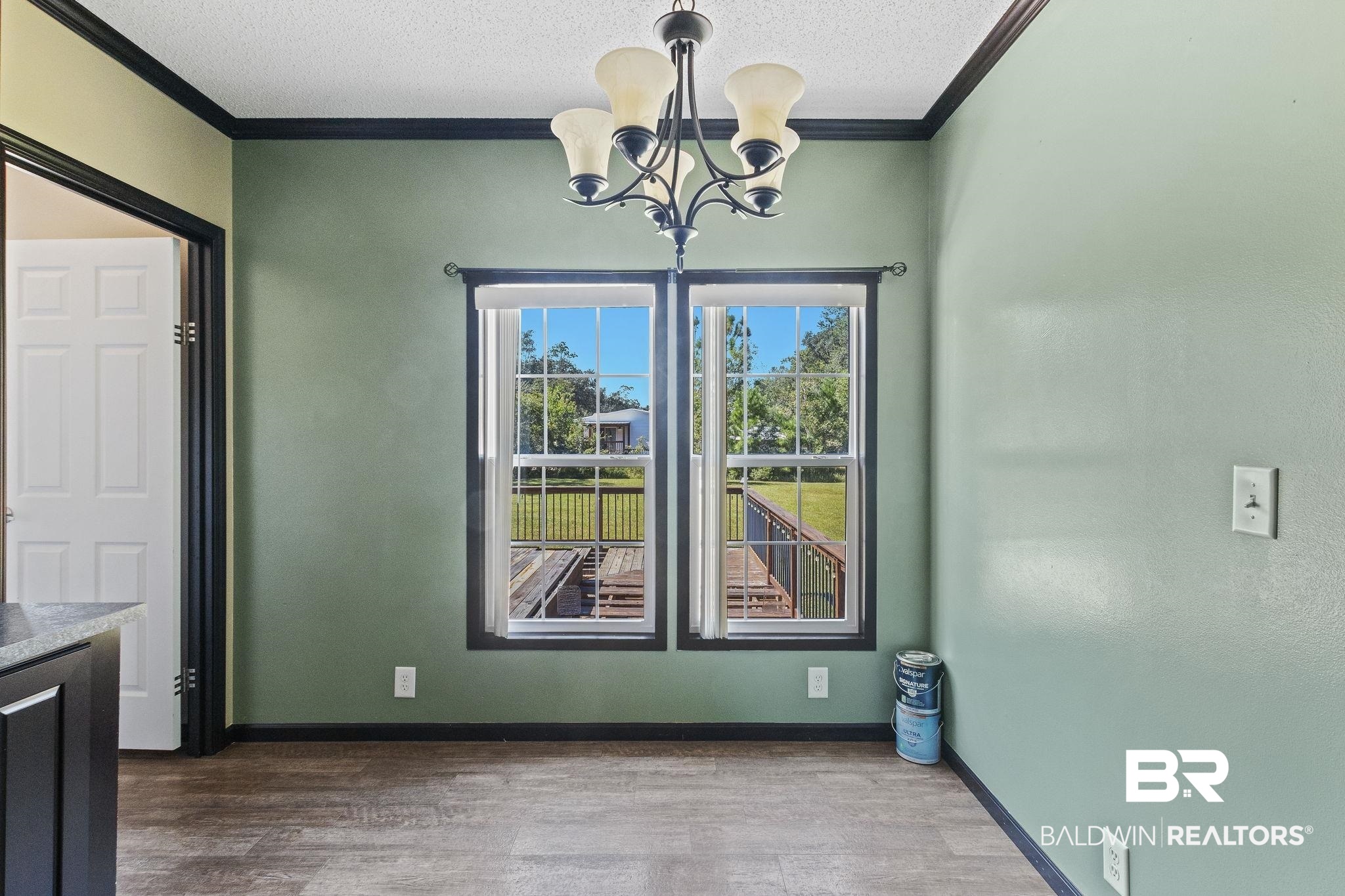 6870 Cecilia Court Theodore, AL 36582 - Photo 26 of 83 Unfurnished dining area with wood-type flooring, a notable chandelier, and crown molding