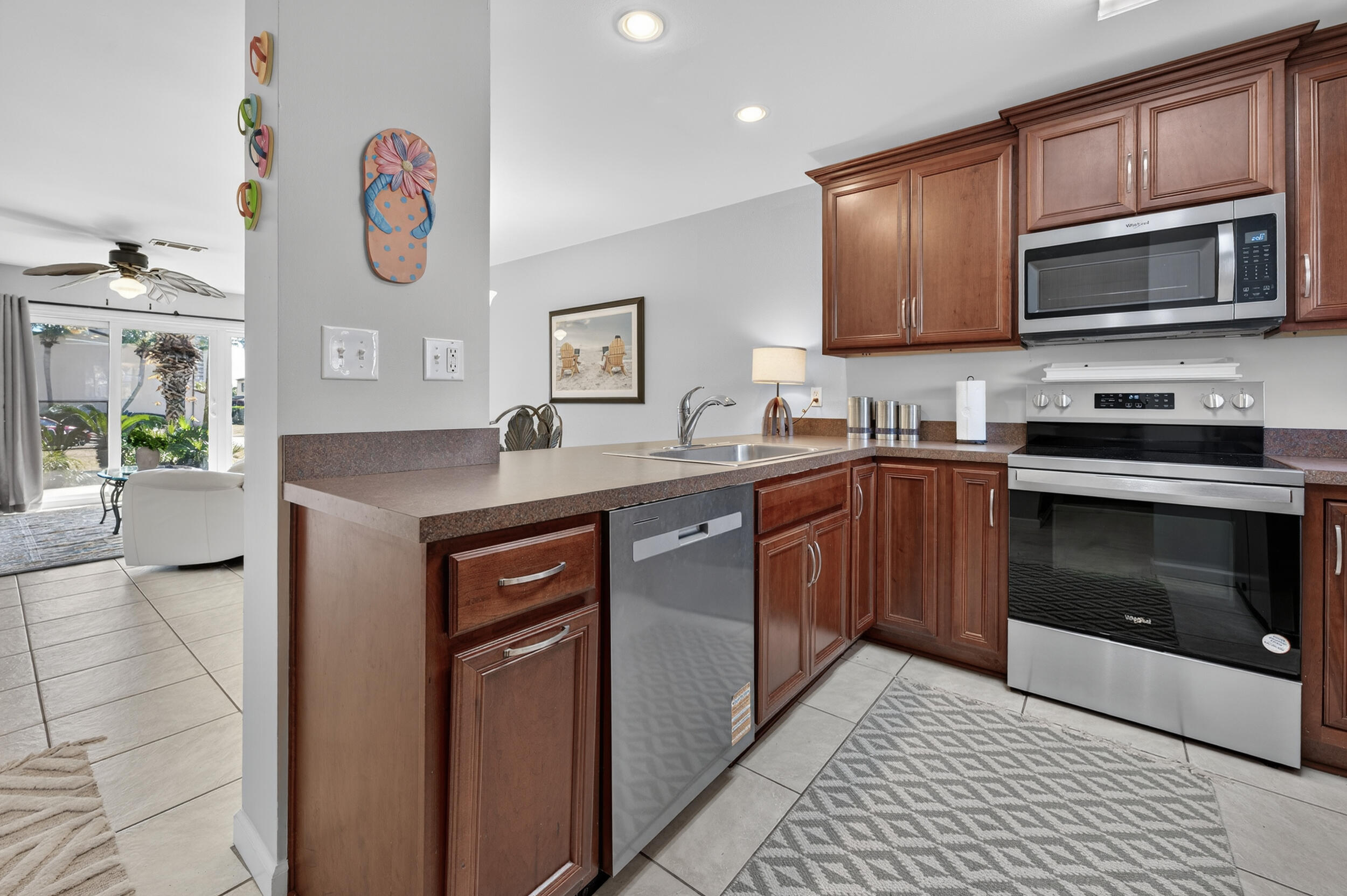 17620 Front Beach Road, Unit BB6 Panama City Beach, FL 32413 - Photo 13 of 47 a kitchen with a sink stove and microwave
