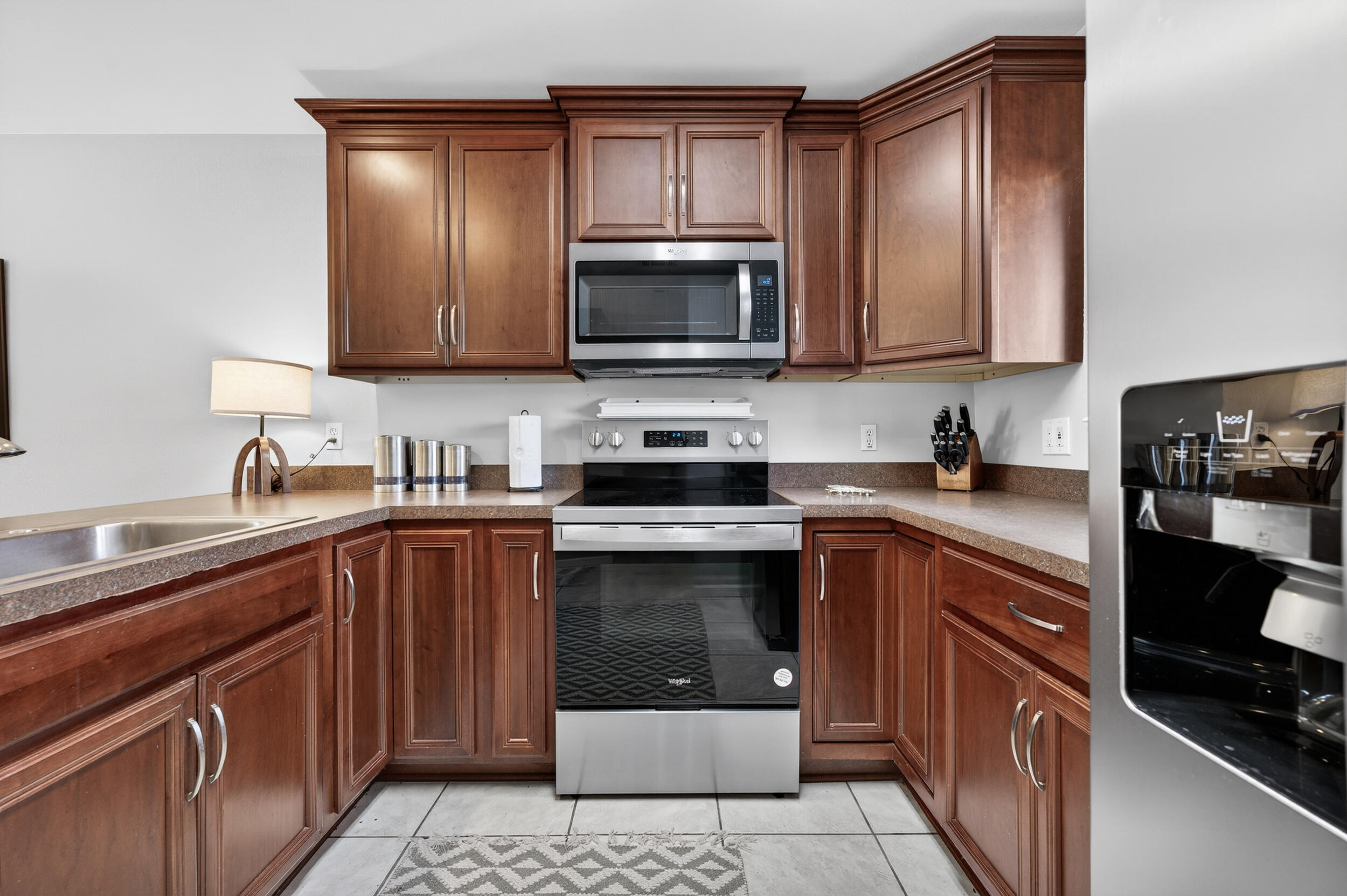 17620 Front Beach Road, Unit BB6 Panama City Beach, FL 32413 - Photo 14 of 47 a kitchen with a sink stove and microwave