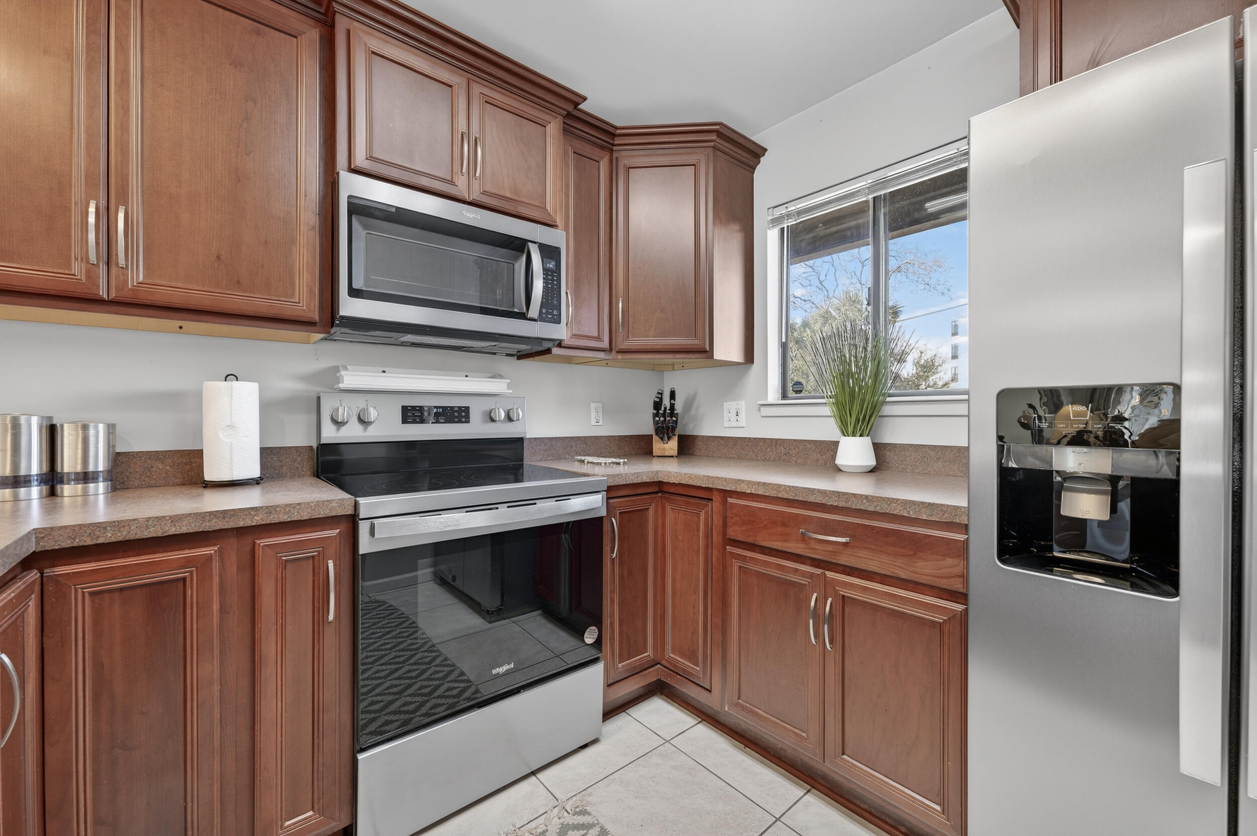 17620 Front Beach Road, Unit BB6 Panama City Beach, FL 32413 - Photo 15 of 47 a kitchen with stainless steel appliances granite countertop a stove microwave and sink