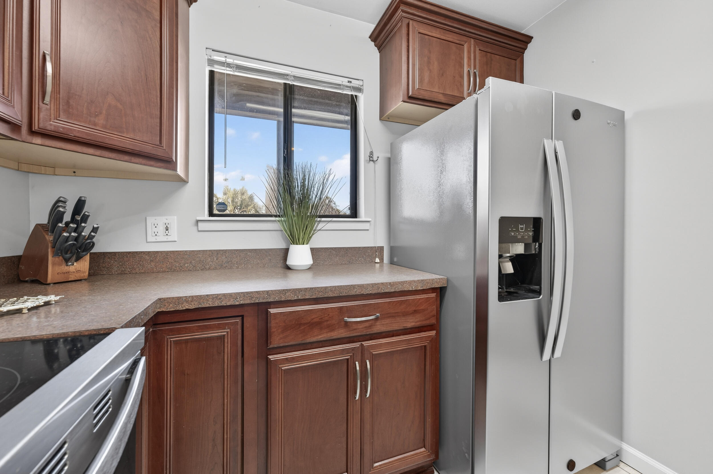 17620 Front Beach Road, Unit BB6 Panama City Beach, FL 32413 - Photo 16 of 47 a kitchen with stainless steel appliances granite countertop a refrigerator and a sink